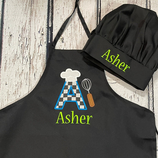 Boys personalized embroidered apron with checkered flag large initial and chef hat in black