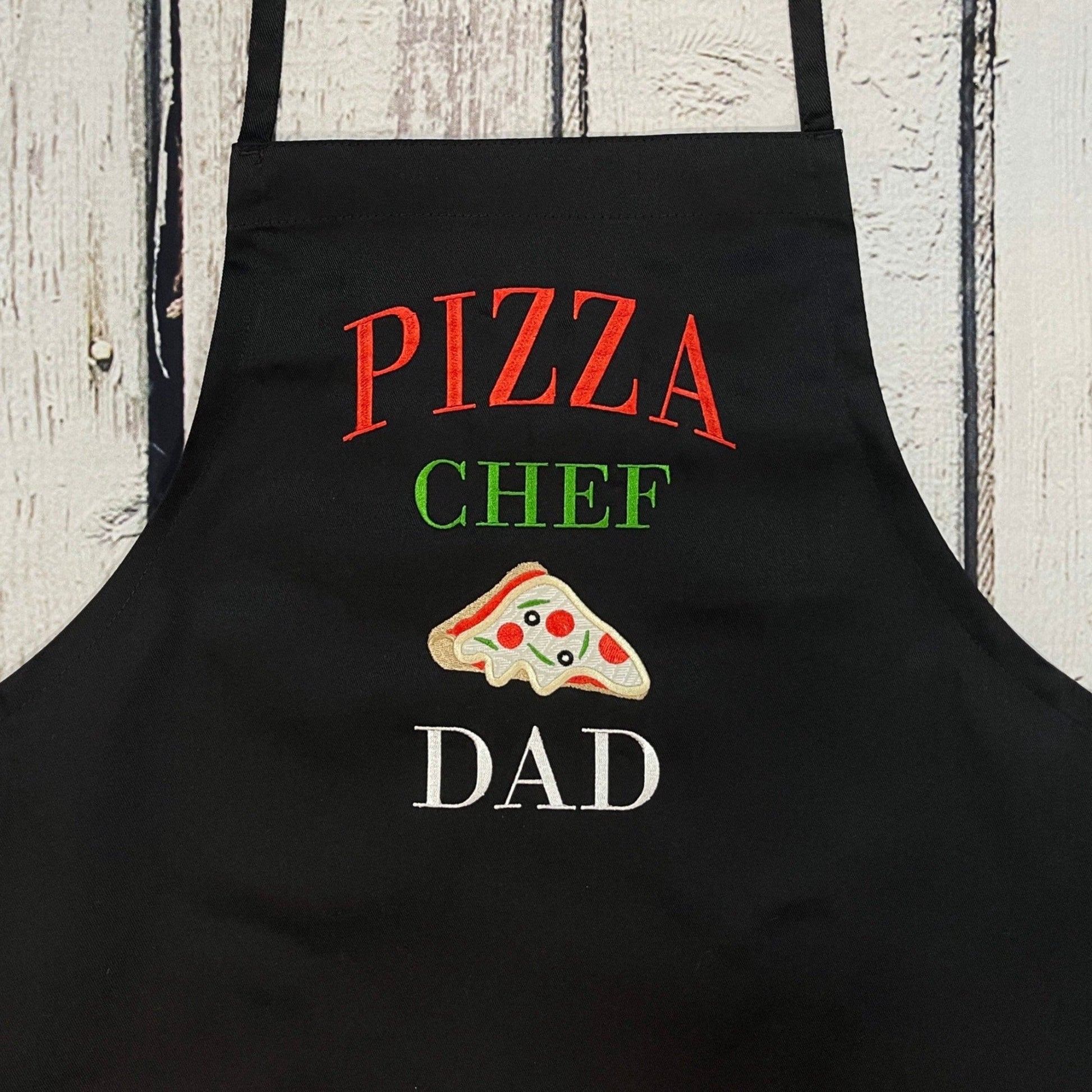 Black apron with pizza chef dad embroidered on the chest.