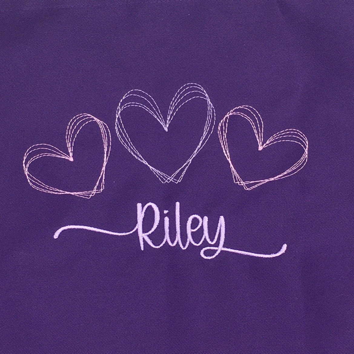 Purple apron for girls with name and hearts embroidered